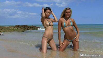 Young sexy pussies posing in bikini at the beach in outdoor vid - sunporno.com